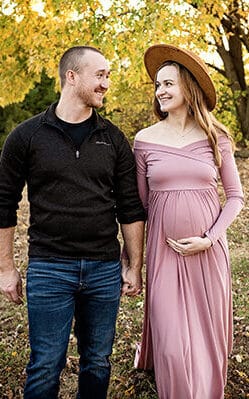 expectant couple walking together