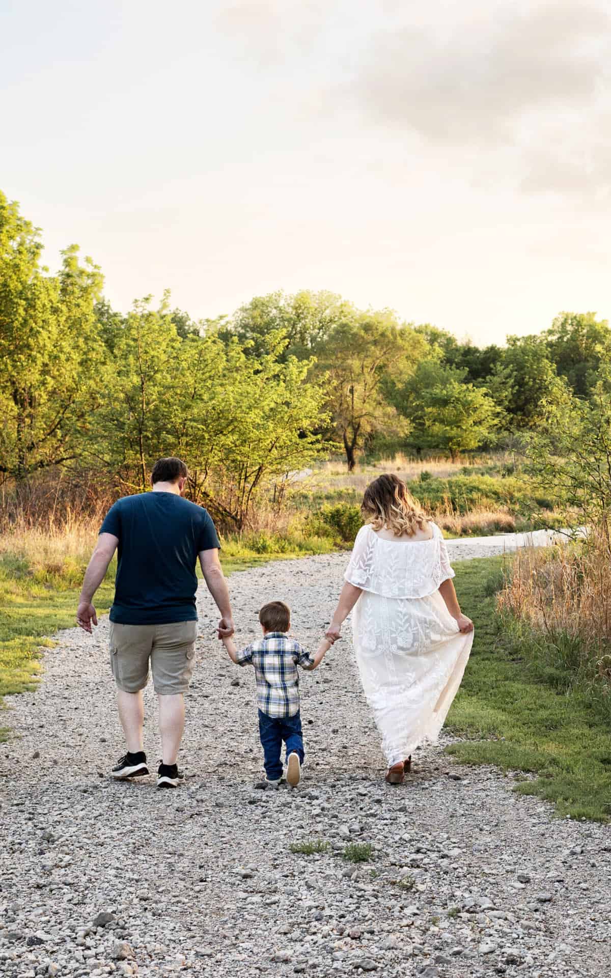 family walking down a path at sunset