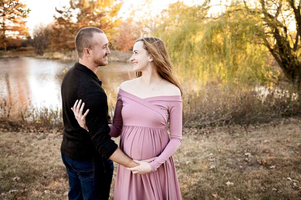 expecting couple poses for maternity photos in hesston