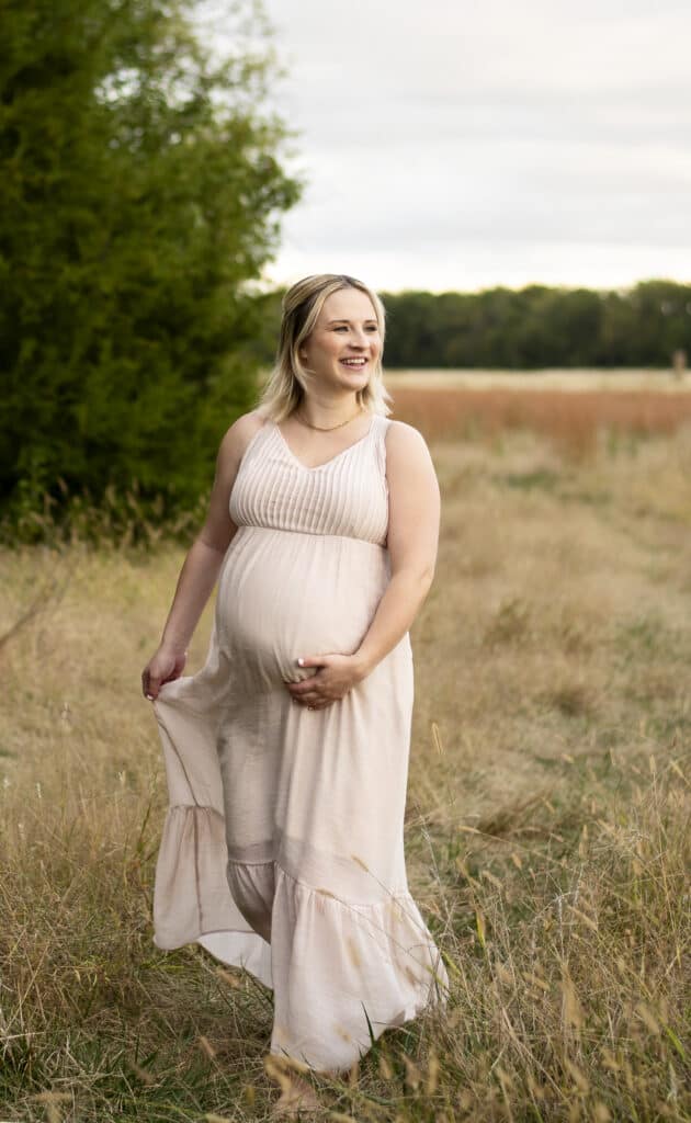 expecting mother walking in a field