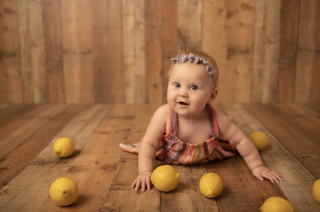 six month milestone photoshoot baby girl with lemons