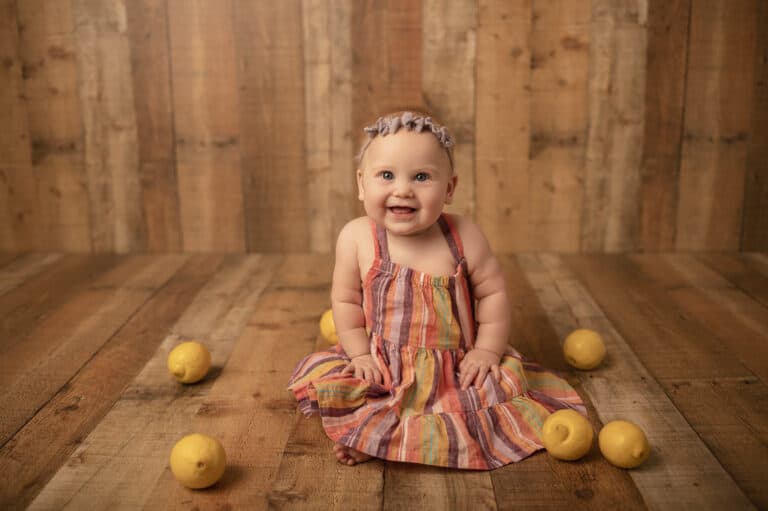 milestone photoshoot baby girl with lemons and purple bow