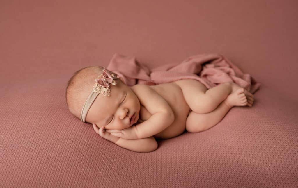 side laying baby girl sleeping for newborn photos