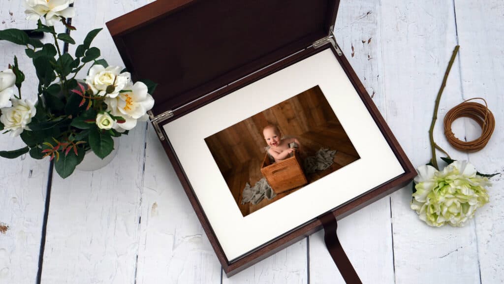 baby photos matted inside a walnut display box